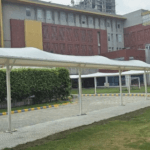 Weatherproof tensile walkway structure covering for outdoor pathways