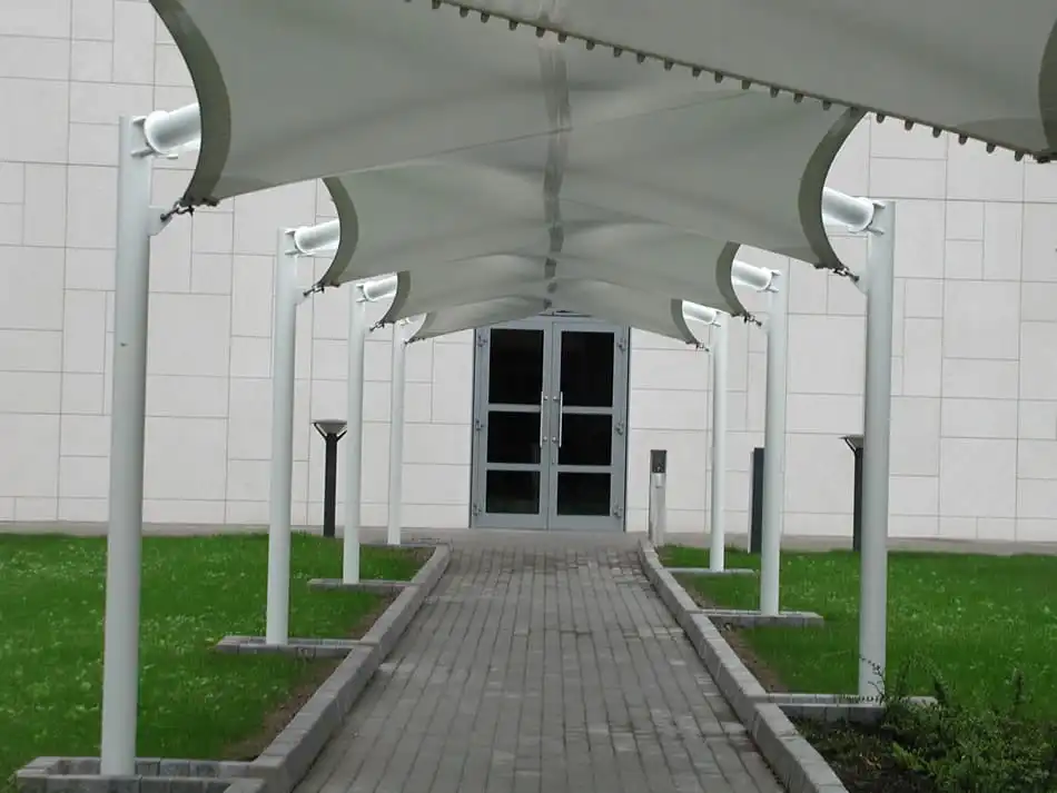 Pedestrian Walkway with a White Fabric Canopy Leading to Glass Doors of a Modern Building