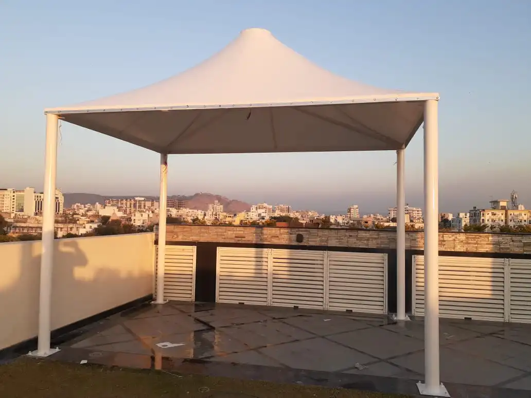 White Canopy Tent on a Rooftop Terrace with a Distant City Skyline at Sunset